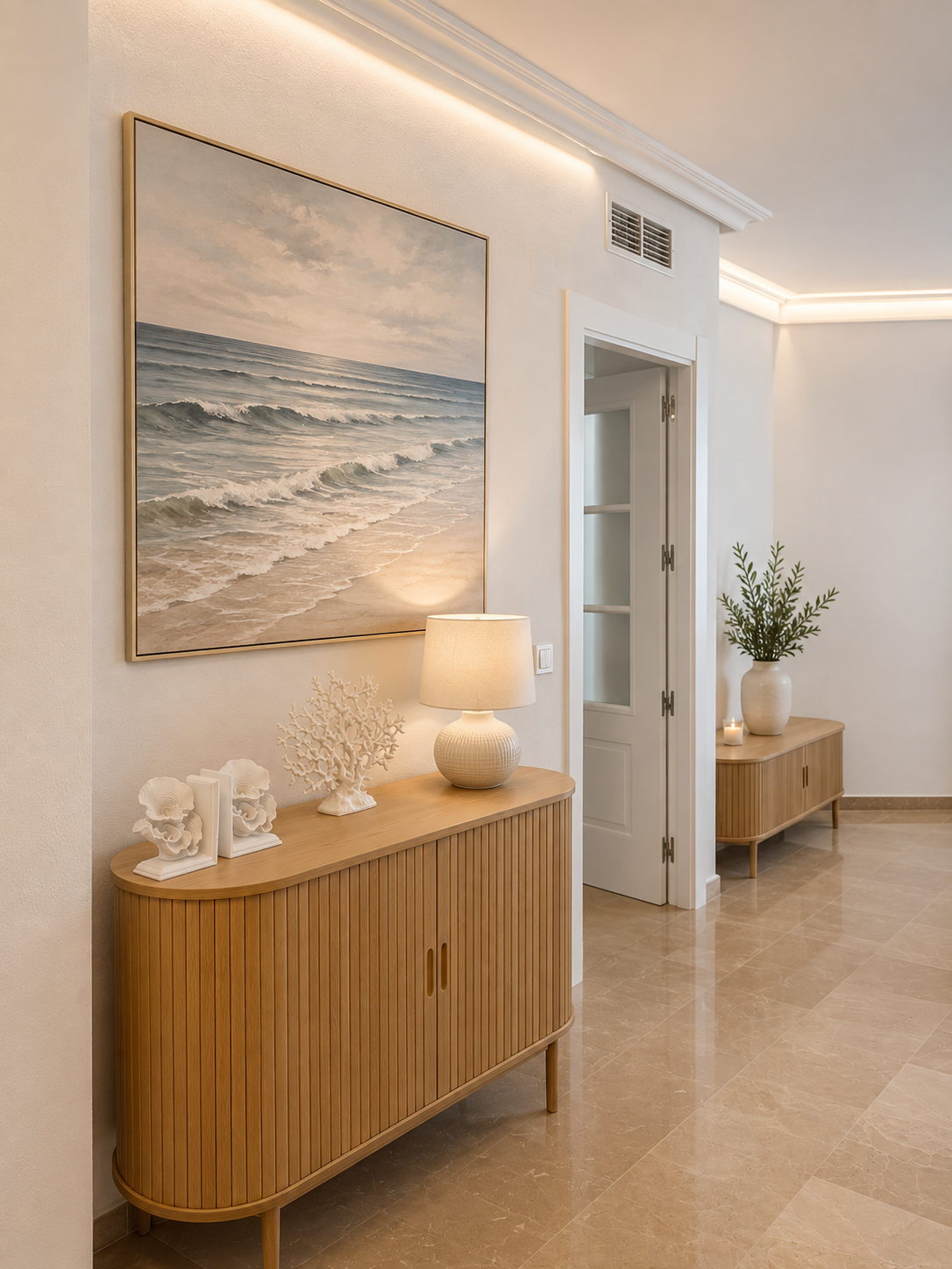 Hallway with oak fluted sideboards, large ocean wave painting and warm cove lighting